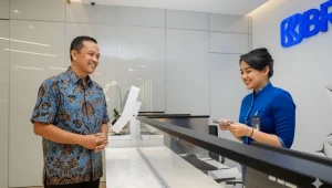 seorang customer sedang mendengarkan penjelasan customer service dari Bank BRI